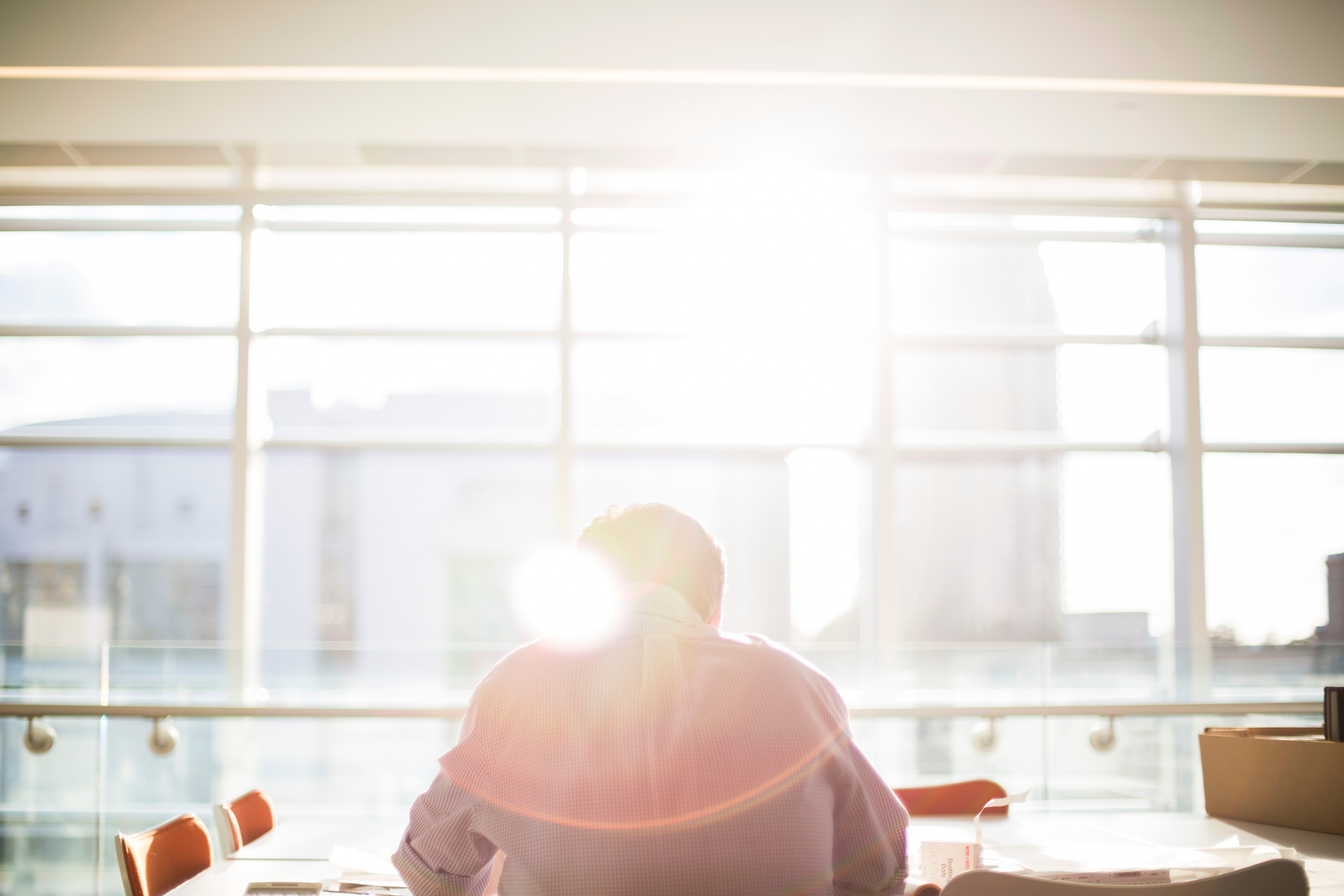 Man at desk by the window with sunshine